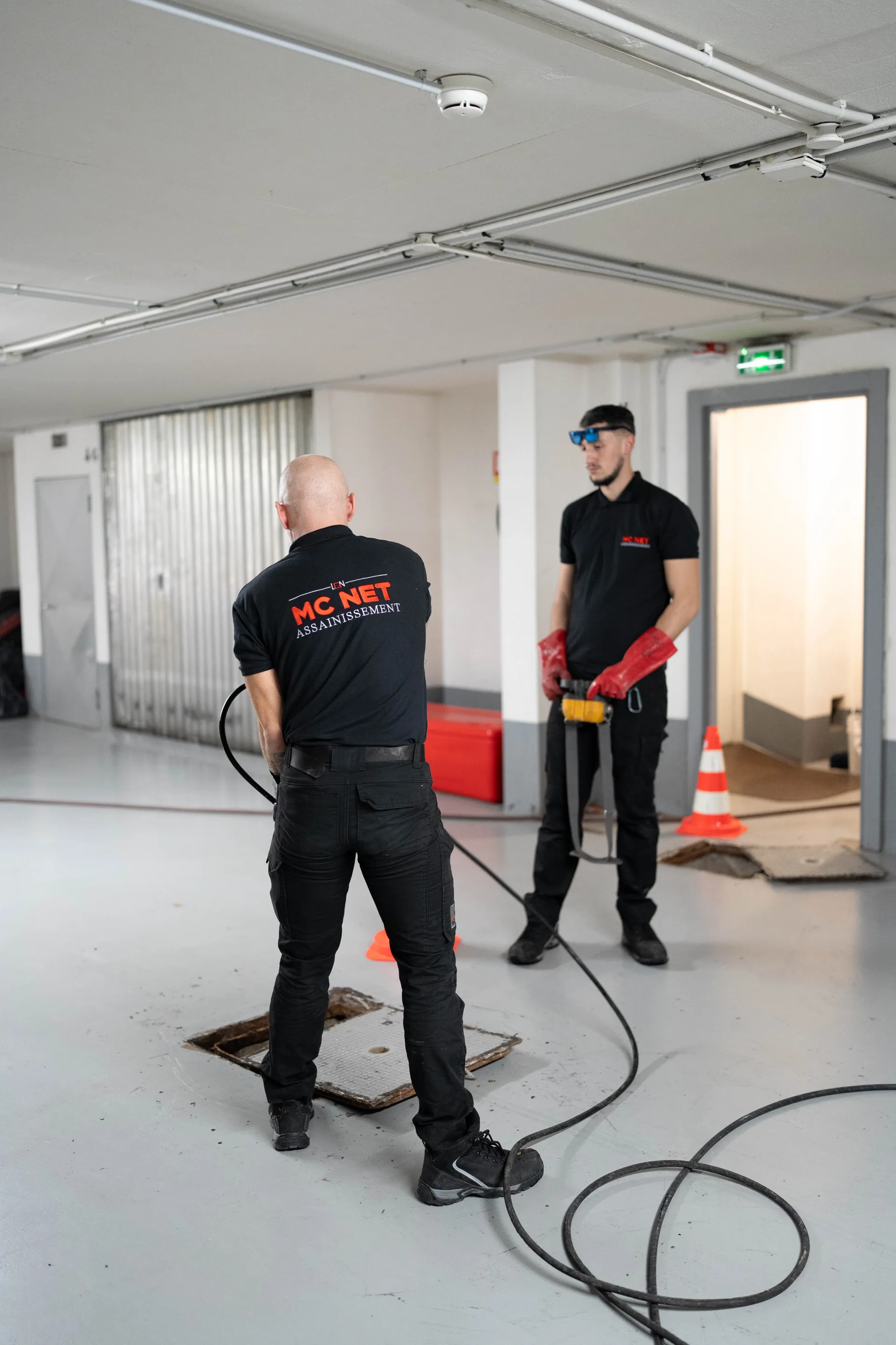MC NET Sanitation technicians preparing a drain cleaning operation