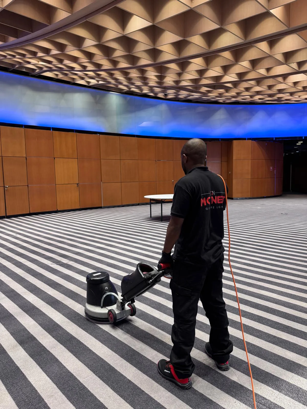 MC NET Cleaning operative polishing a conference hall floor in Monaco